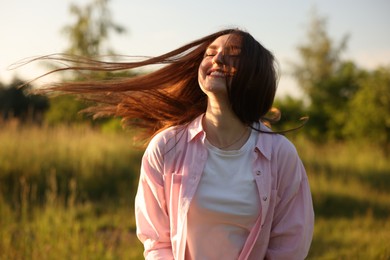 Photo of Feeling freedom. Happy young woman enjoying time in nature
