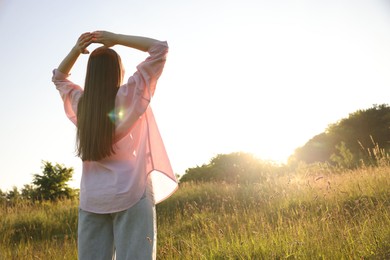 Photo of Feeling freedom. Woman enjoying time in nature, back view. Space for text