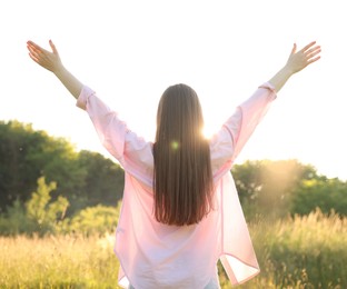 Photo of Feeling freedom. Woman enjoying time in nature, back view