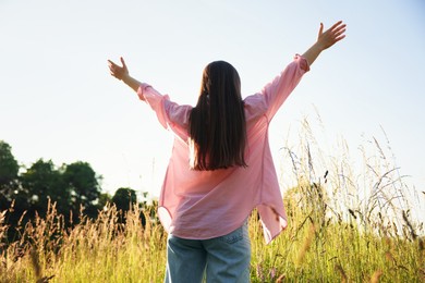 Photo of Feeling freedom. Woman enjoying time in nature, low angle view