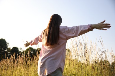 Photo of Feeling freedom. Woman enjoying time in nature, low angle view