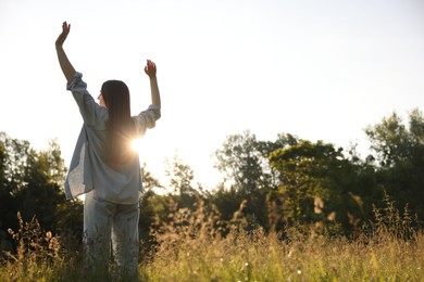 Photo of Feeling freedom. Woman enjoying time in nature, low angle view. Space for text