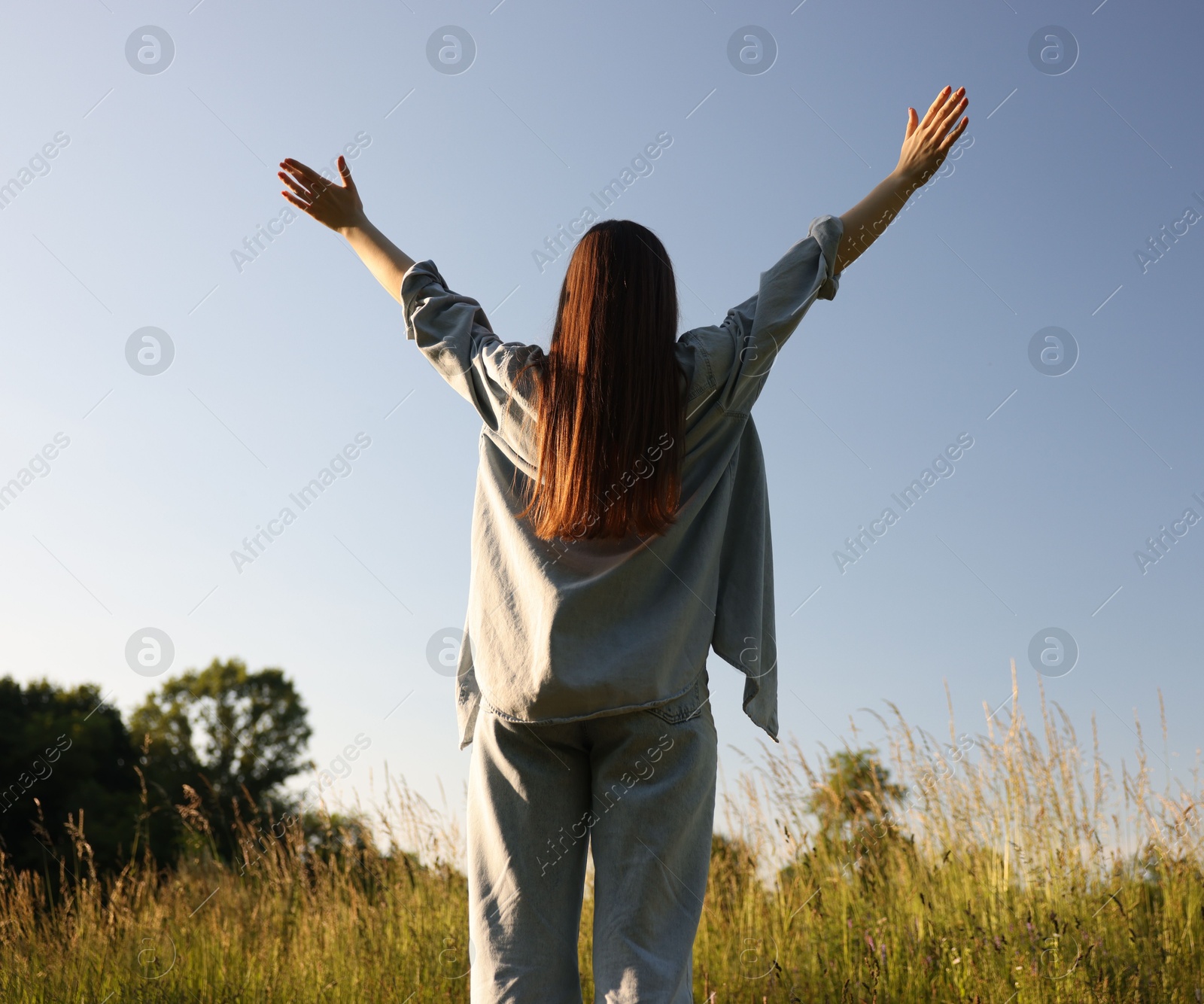 Photo of Feeling freedom. Woman enjoying time in nature, back view