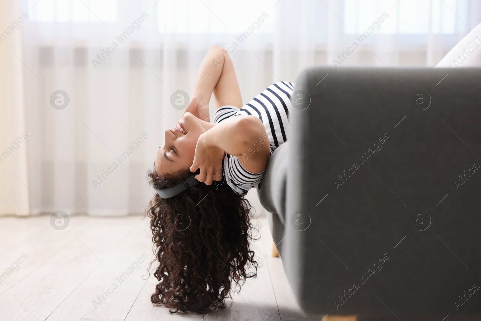 Photo of Young woman with headphones listening to music at home