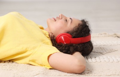 Photo of Young woman with headphones listening to music at home