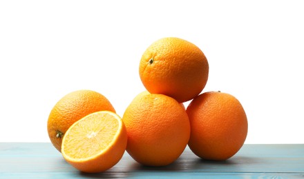 Photo of Pile of juicy oranges on light blue wooden table against white background