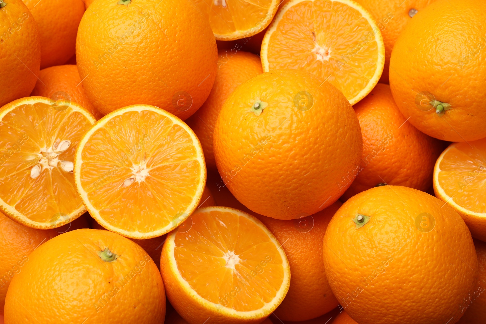 Fresh cut and whole oranges as background, top view Photo of Fresh cut and whole oranges as background, top view