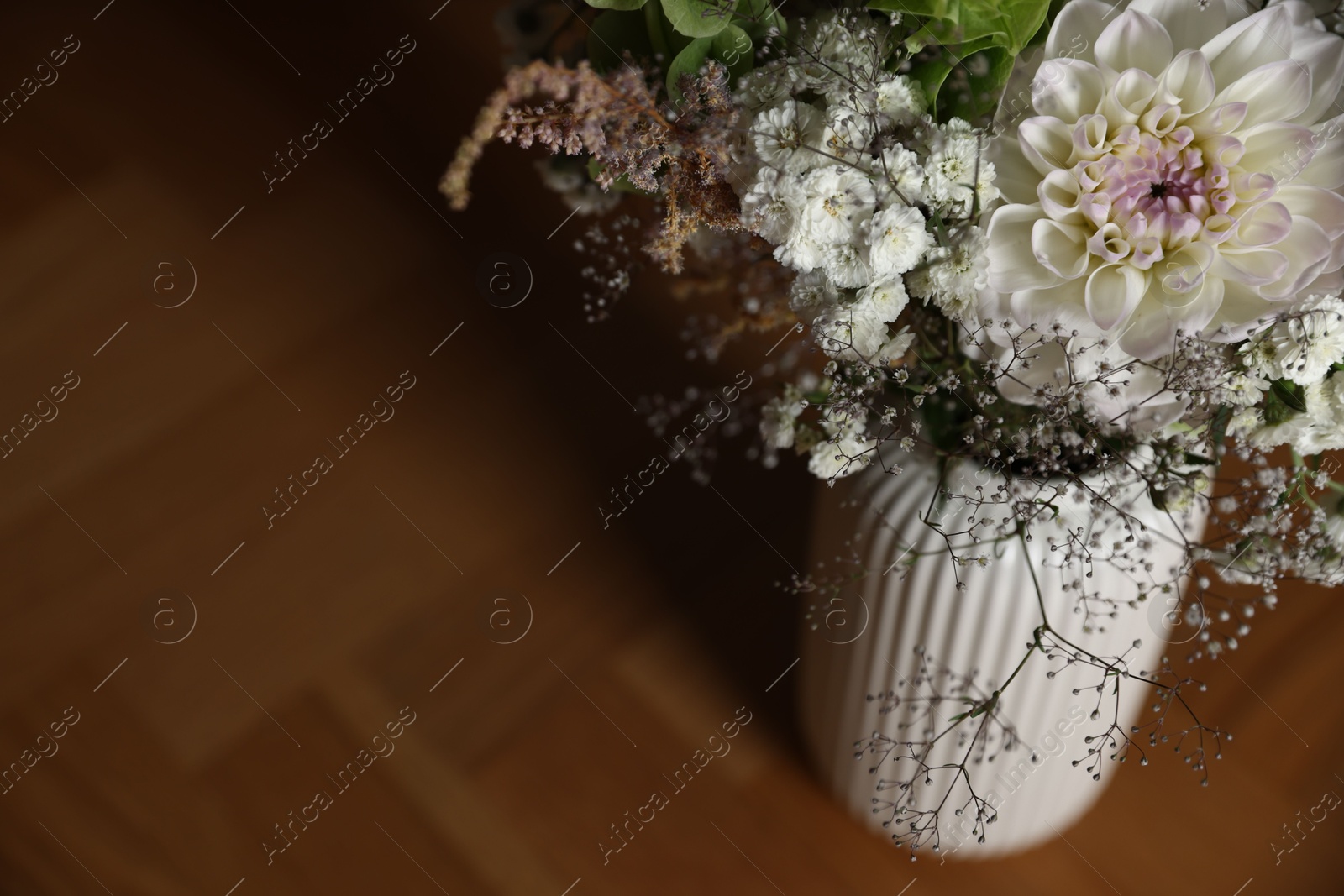 Beautiful flowers in vase on wooden table, closeup. Space for text Photo of Beautiful flowers in vase on wooden table, closeup. Space for text