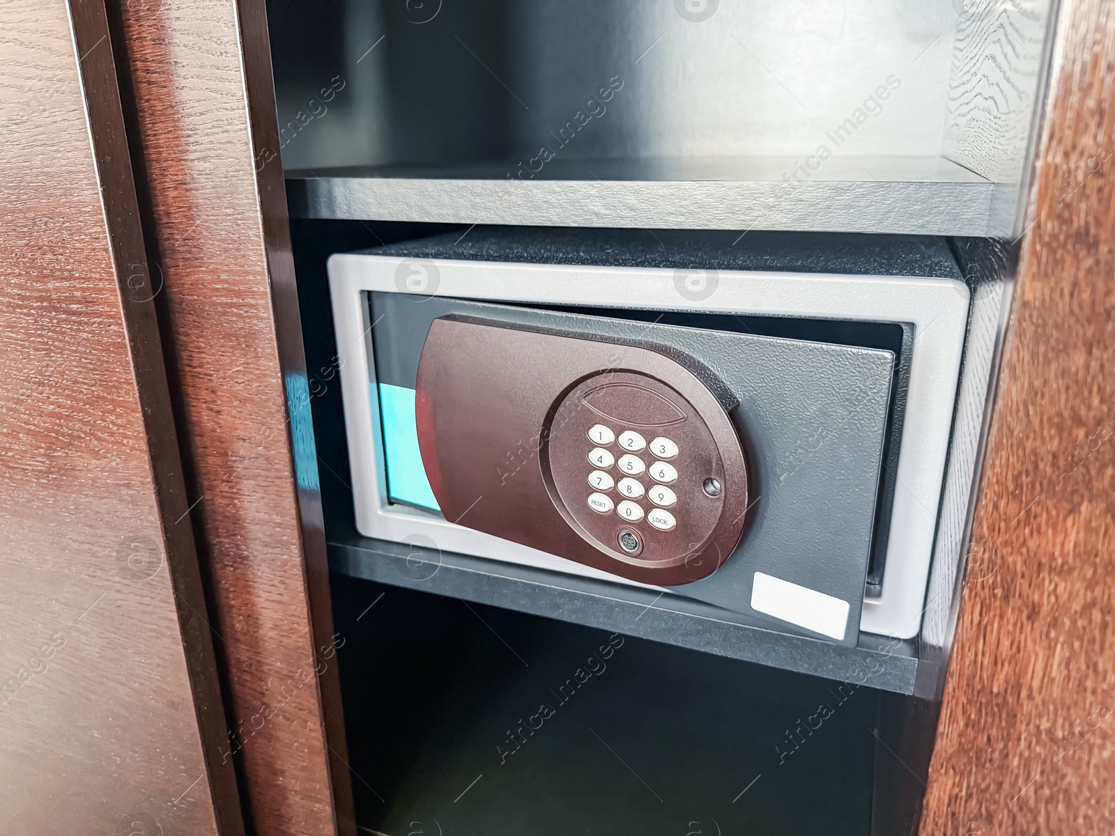 Photo of Steel safe with electronic lock indoors, closeup
