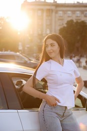 Photo of Beautiful woman near modern car outdoors on sunny day