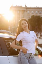 Photo of Beautiful woman near modern car outdoors on sunny day