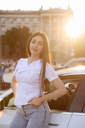 Photo of Beautiful woman near modern car outdoors on sunny day
