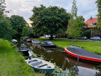 Photo of Picturesque view of canal with moored boats outdoors