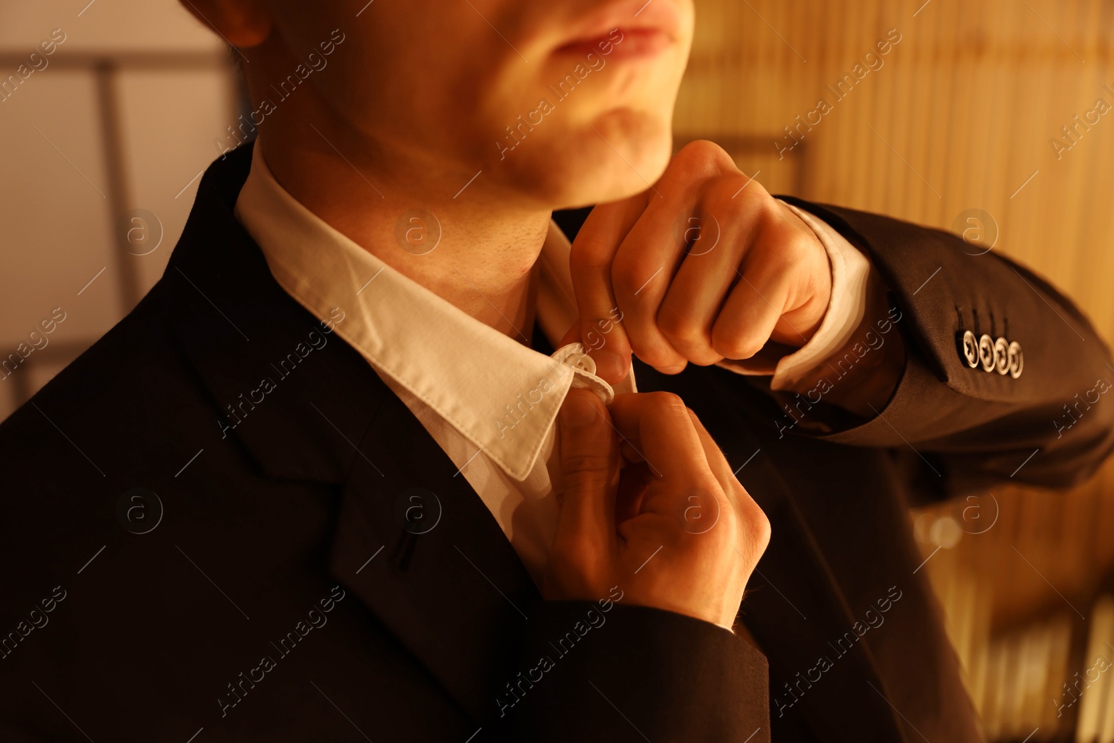 Man in stylish outfit getting ready indoors, closeup Photo of Man in stylish outfit getting ready indoors, closeup
