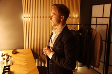 Photo of Man in stylish outfit getting ready indoors
