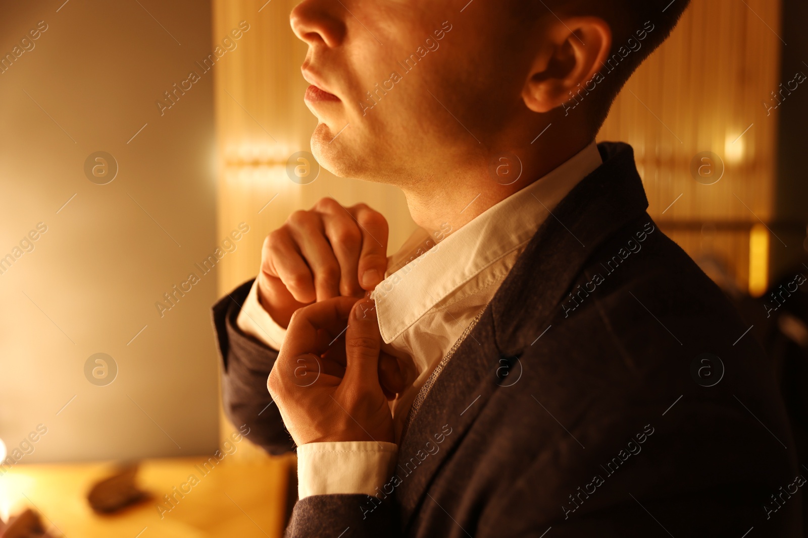 Man in stylish outfit getting ready indoors, closeup Photo of Man in stylish outfit getting ready indoors, closeup