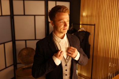 Photo of Man in stylish outfit getting ready indoors