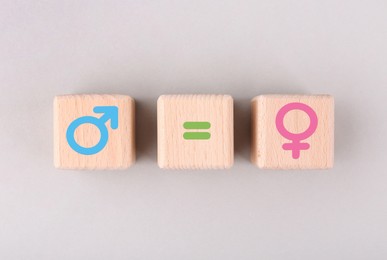 Image of Sex education. Wooden cubes with female and male gender symbols and equals sign on white background, top view