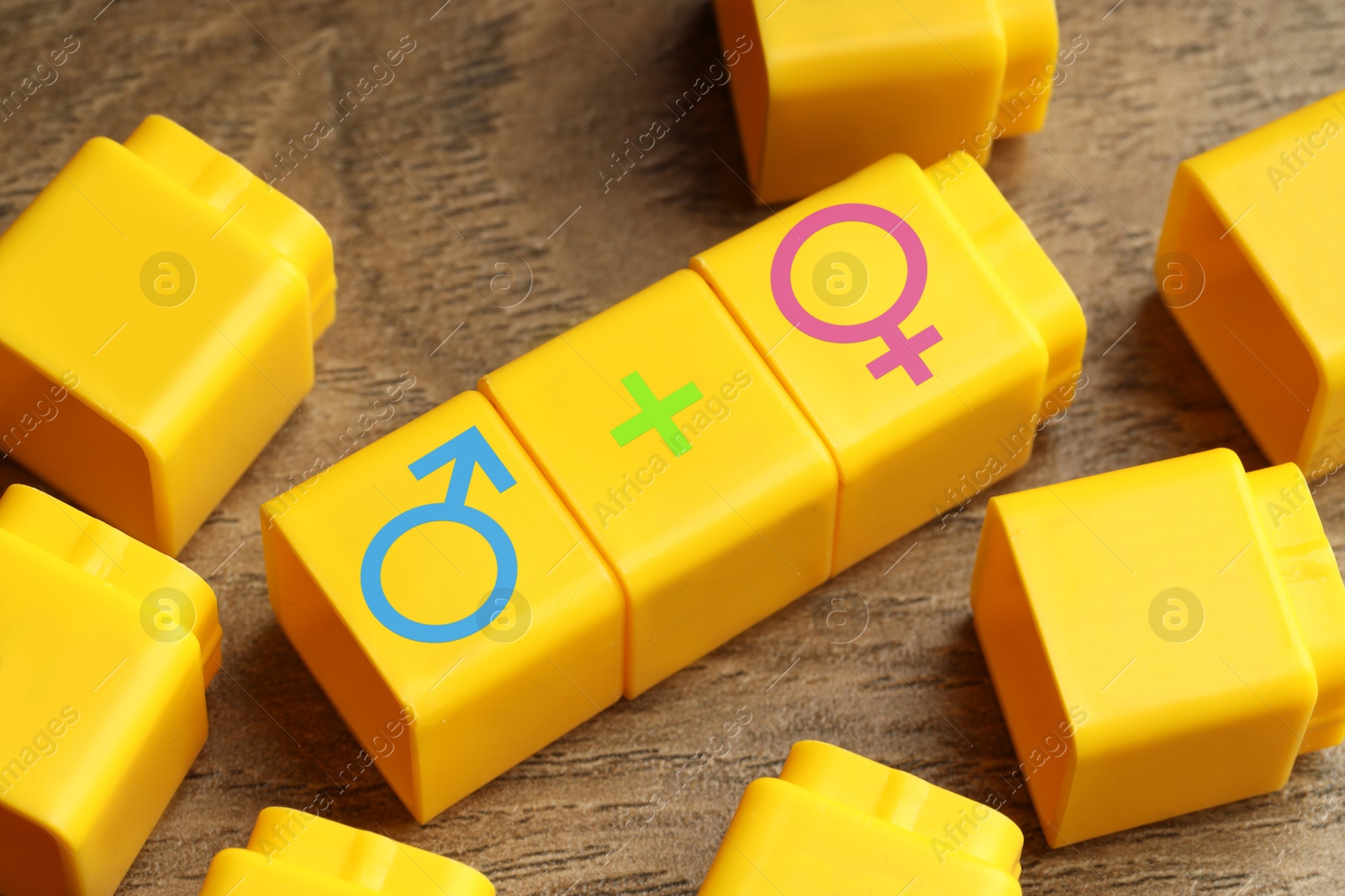 Sex education. Yellow cubes with female and male gender symbols and plus sign on wooden background Image of Sex education. Yellow cubes with female and male gender symbols and plus sign on wooden background