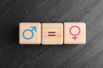 Image of Sex education. Wooden cubes with female and male gender symbols and equals sign on grey textured background, top view