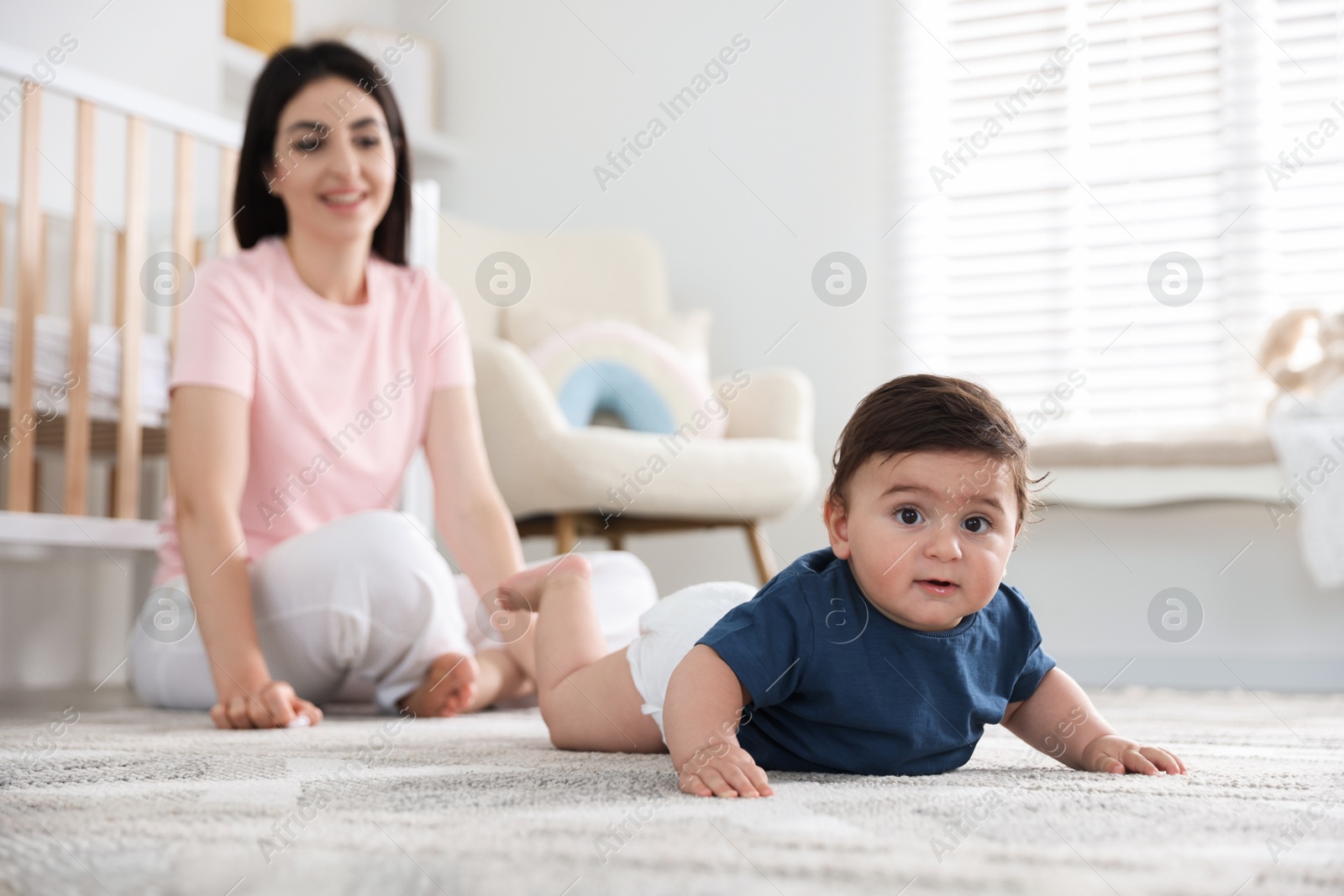 Happy mother with her cute little baby at home, selective focus Photo of Happy mother with her cute little baby at home, selective focus