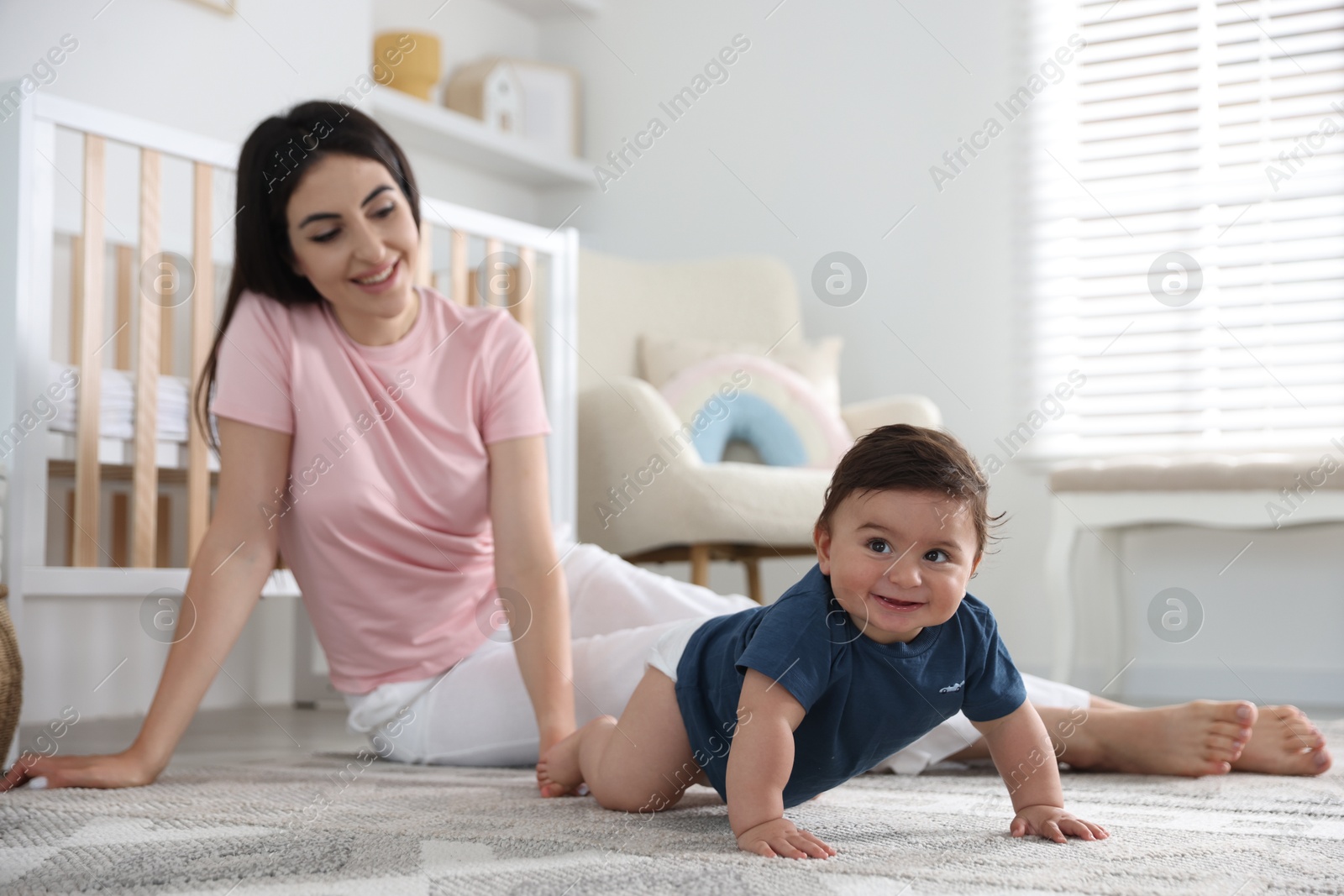 Happy mother with her cute little baby at home, selective focus Photo of Happy mother with her cute little baby at home, selective focus