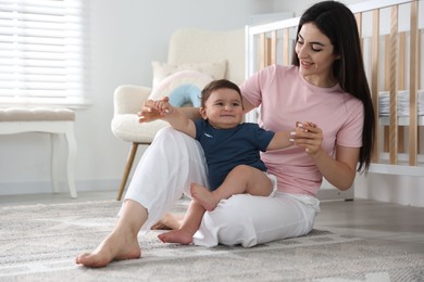Photo of Happy mother with her cute little baby at home