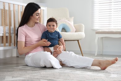 Photo of Happy mother with her cute little baby at home