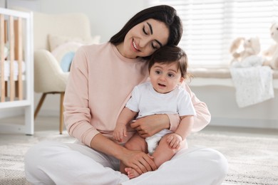 Photo of Happy mother with her cute little baby at home