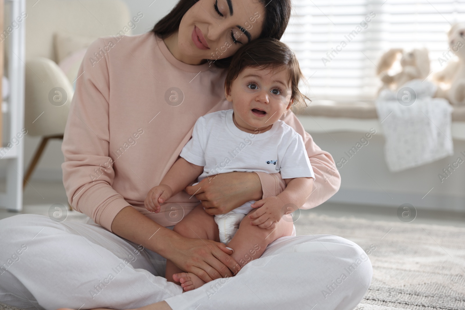 Happy mother with her cute little baby at home Photo of Happy mother with her cute little baby at home