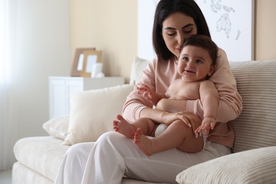 Photo of Happy mother with her cute little baby at home, space for text