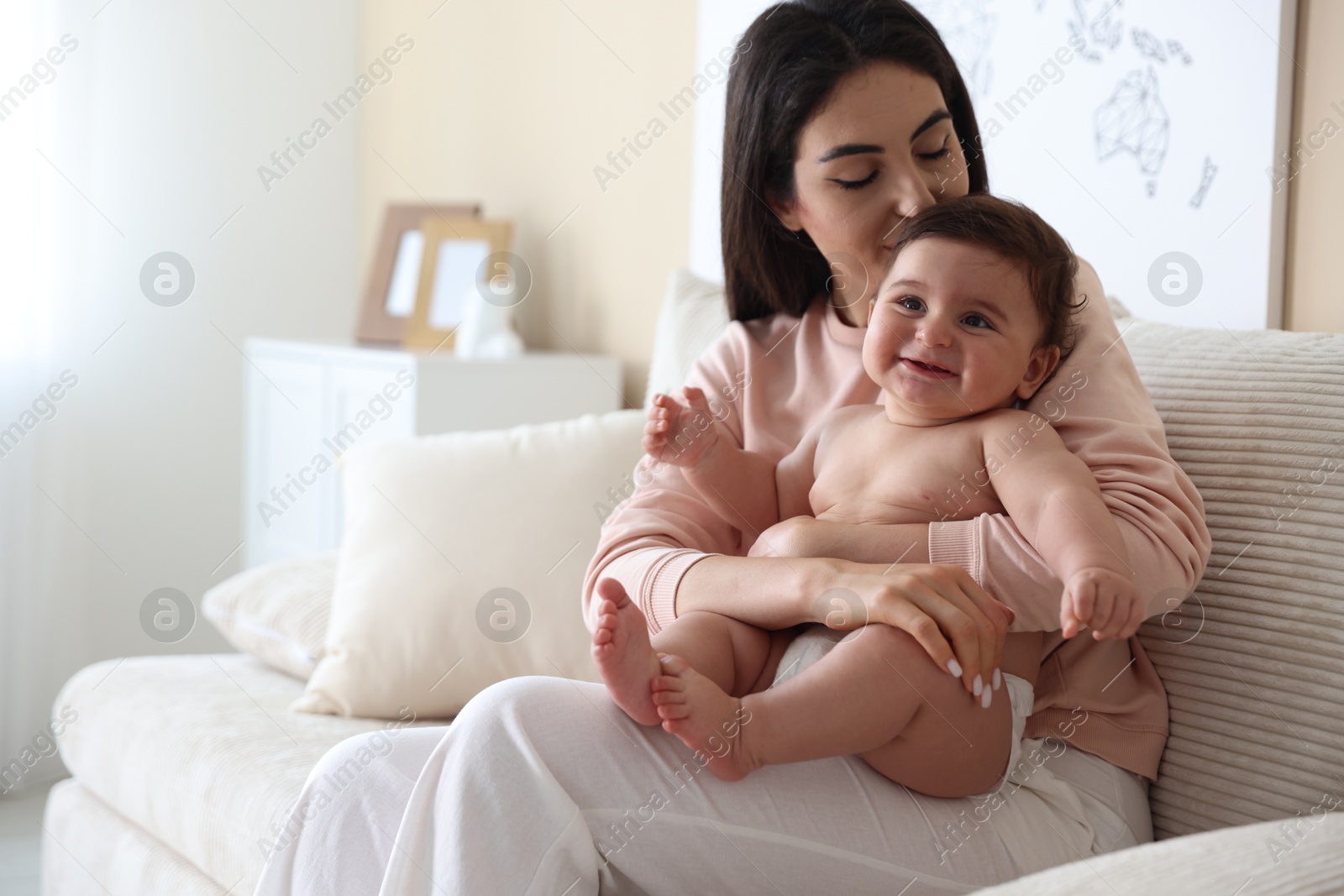 Photo of Happy mother with her cute little baby at home, space for text