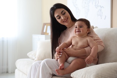 Photo of Happy mother with her cute little baby at home, space for text