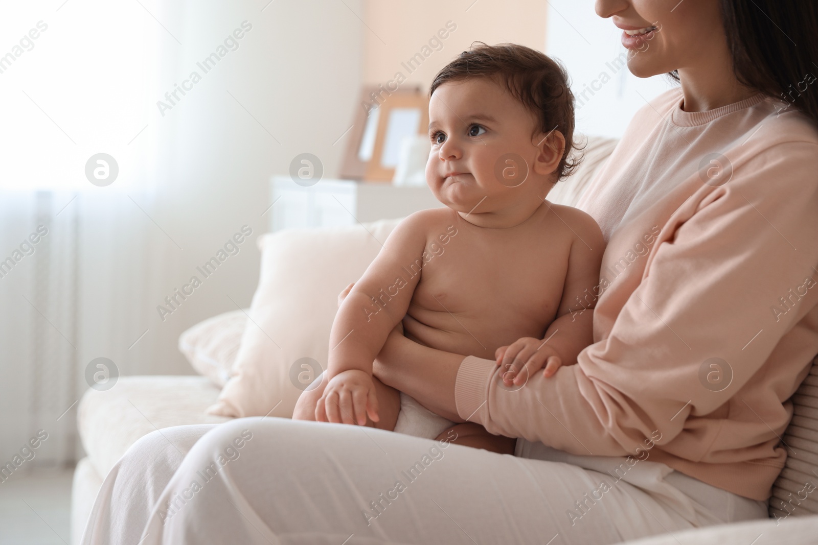 Happy mother with her cute little baby at home, closeup. Space for text Photo of Happy mother with her cute little baby at home, closeup. Space for text