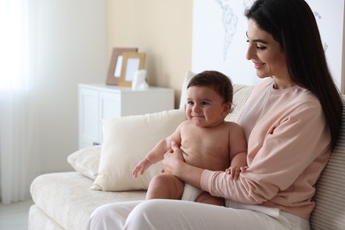 Photo of Happy mother with her cute little baby at home, space for text