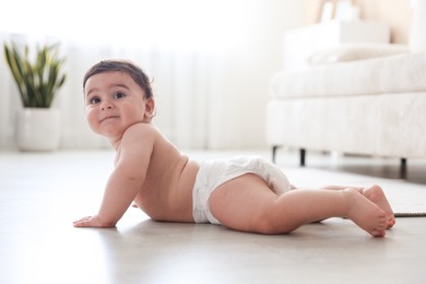 Photo of Cute little baby crawling on floor at home