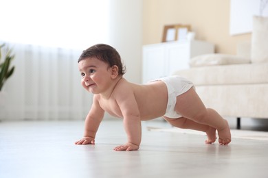 Photo of Cute little baby crawling on floor at home