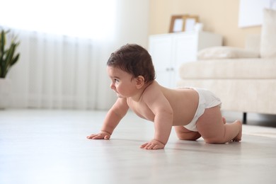 Photo of Cute little baby crawling on floor at home