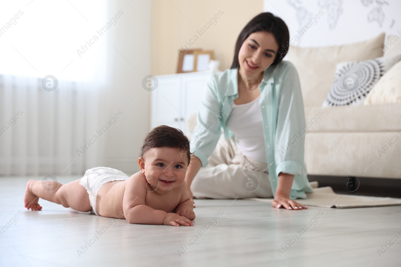 Happy mother with her cute little baby at home, selective focus Photo of Happy mother with her cute little baby at home, selective focus