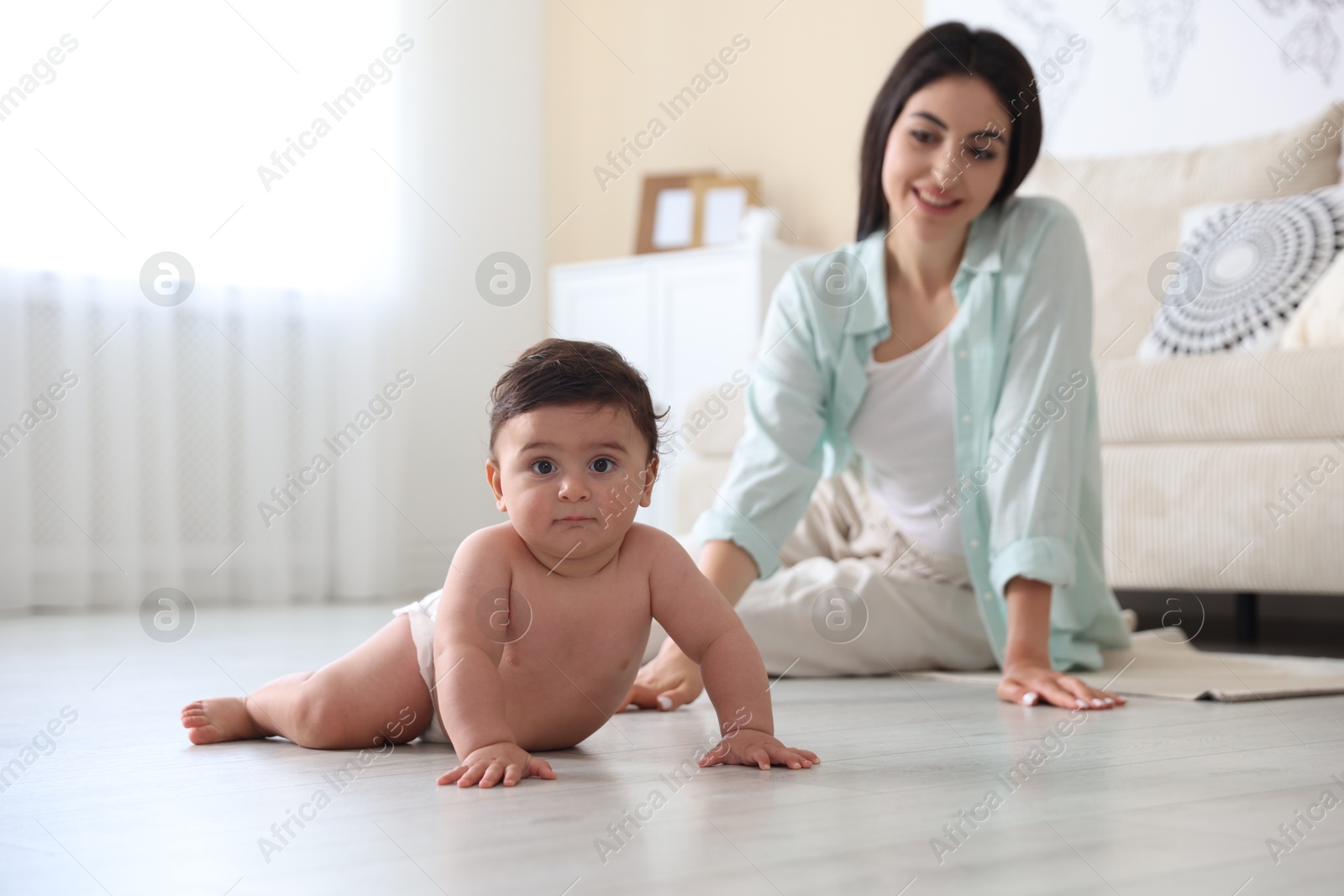 Happy mother with her cute little baby at home, selective focus Photo of Happy mother with her cute little baby at home, selective focus