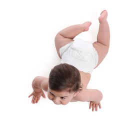 Photo of Cute little baby crawling on white background, above view