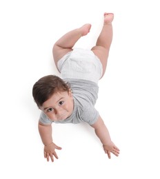 Photo of Cute little baby crawling on white background, above view