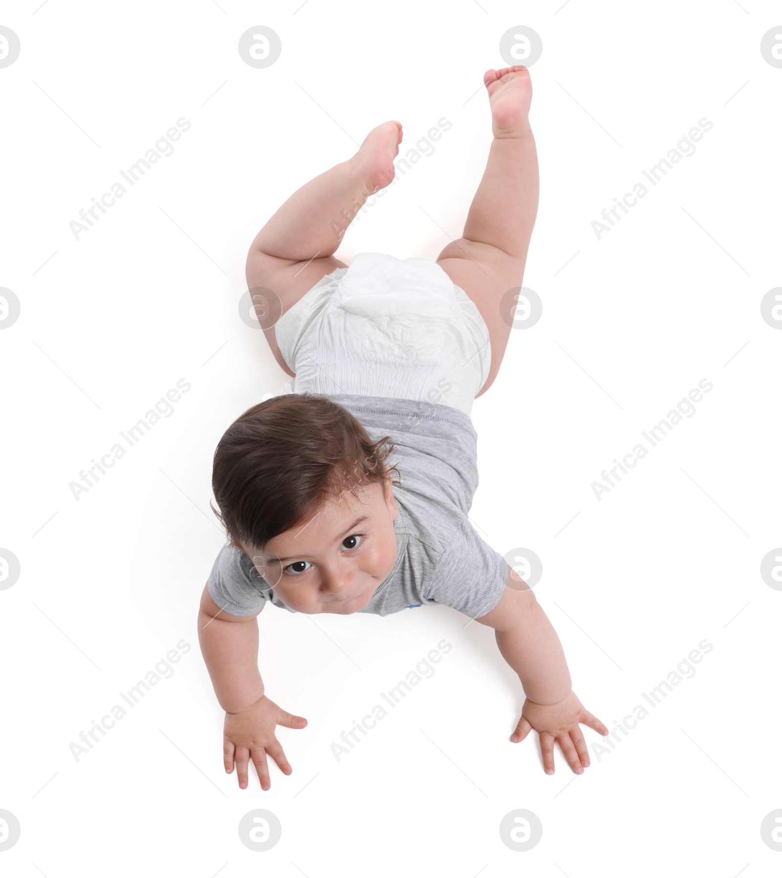 Cute little baby crawling on white background, above view Photo of Cute little baby crawling on white background, above view