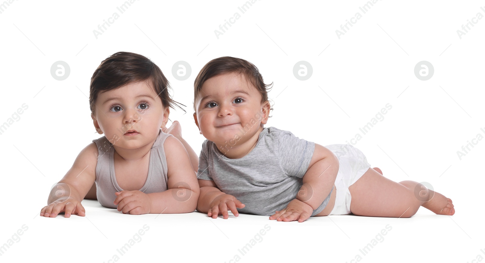 Cute little twin babies on white background Photo of Cute little twin babies on white background