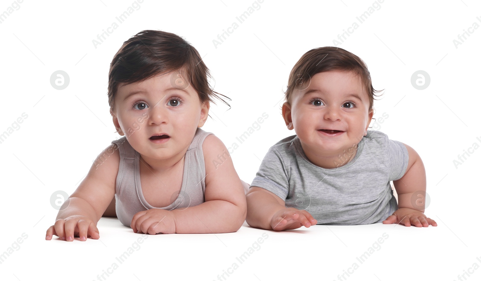 Cute little twin babies on white background Photo of Cute little twin babies on white background
