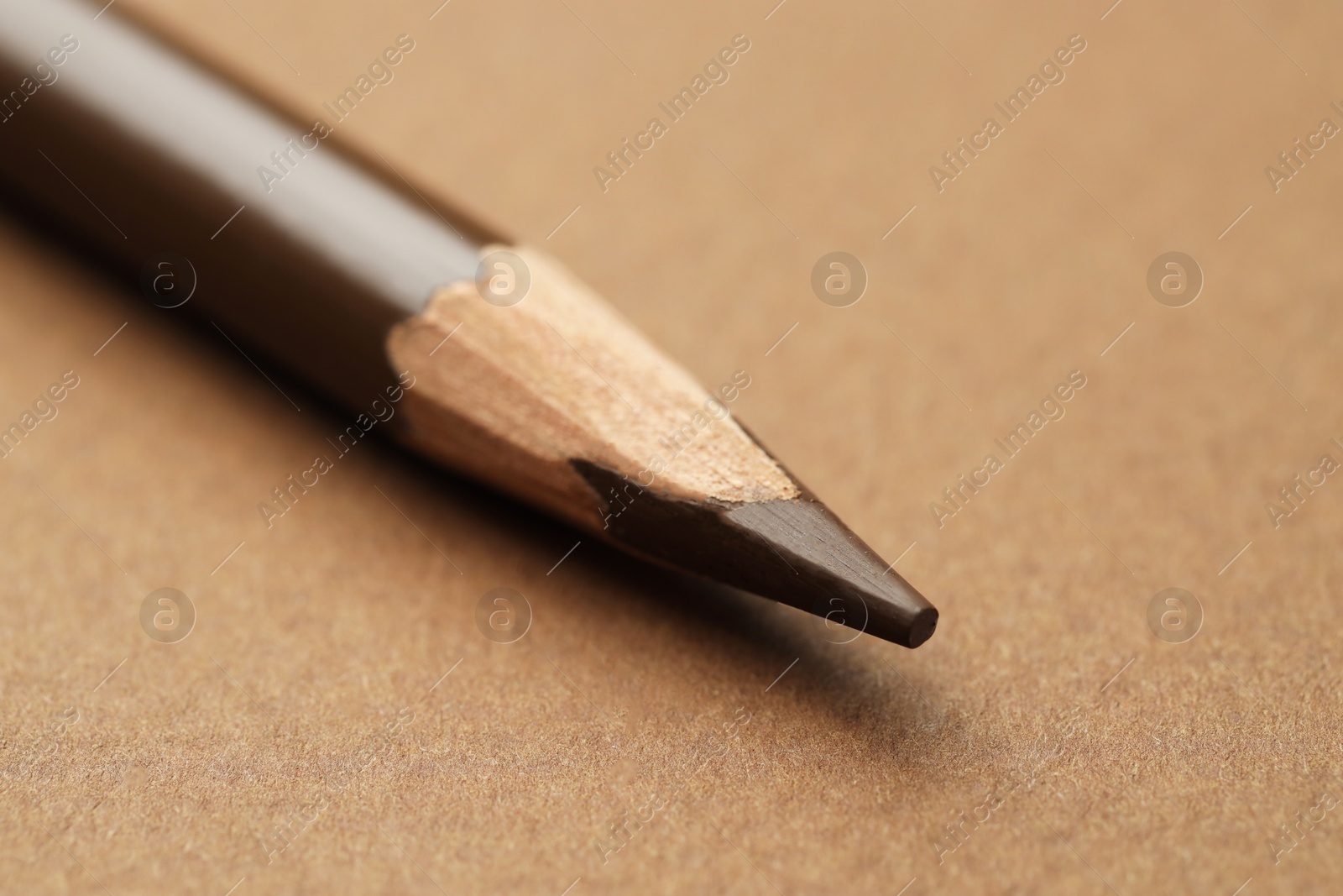 One eyebrow pencil on brown background, macro view Photo of One eyebrow pencil on brown background, macro view