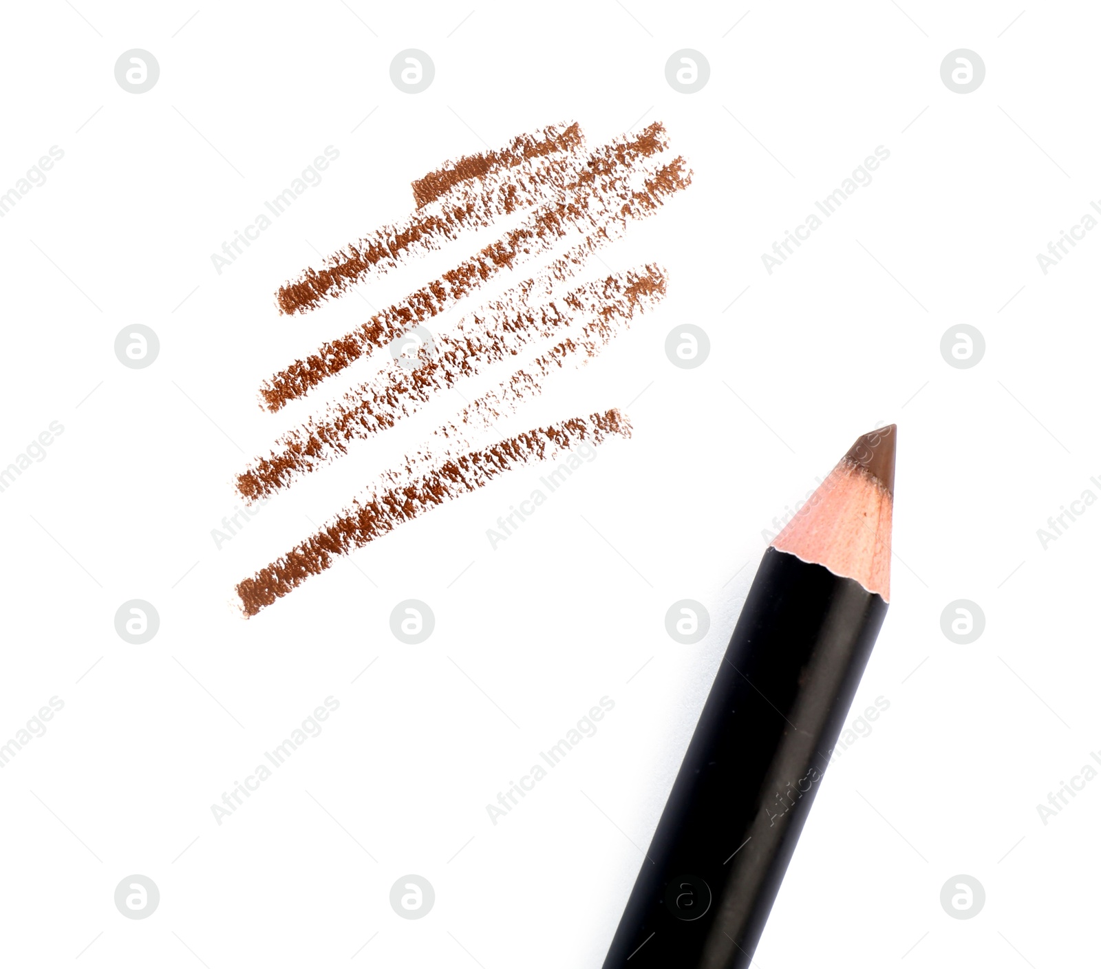 Eyebrow pencil and strokes isolated on white, top view Photo of Eyebrow pencil and strokes isolated on white, top view