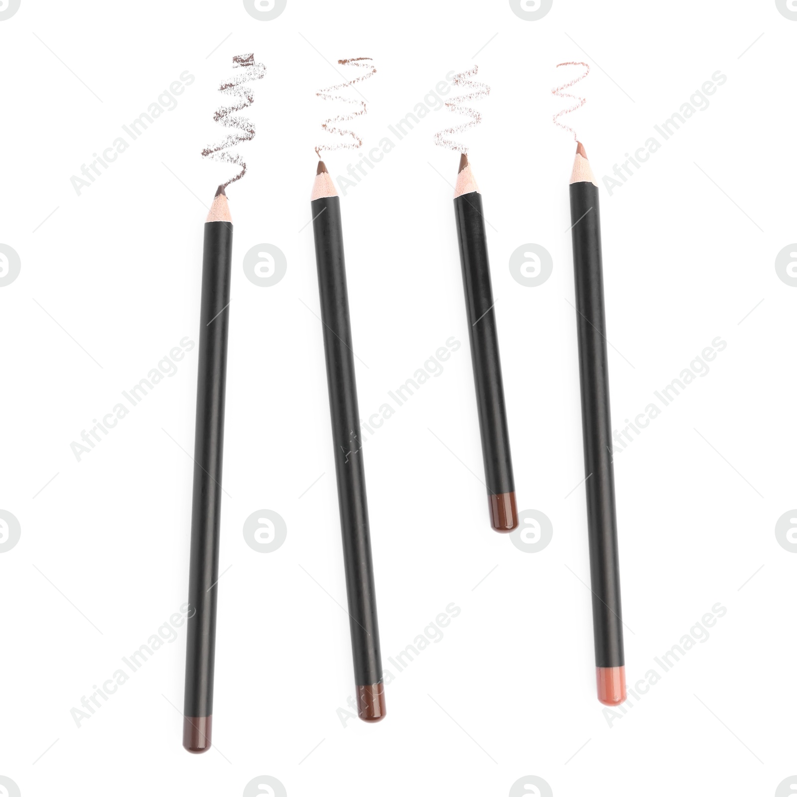 Photo of Eyebrow pencils and strokes isolated on white, top view