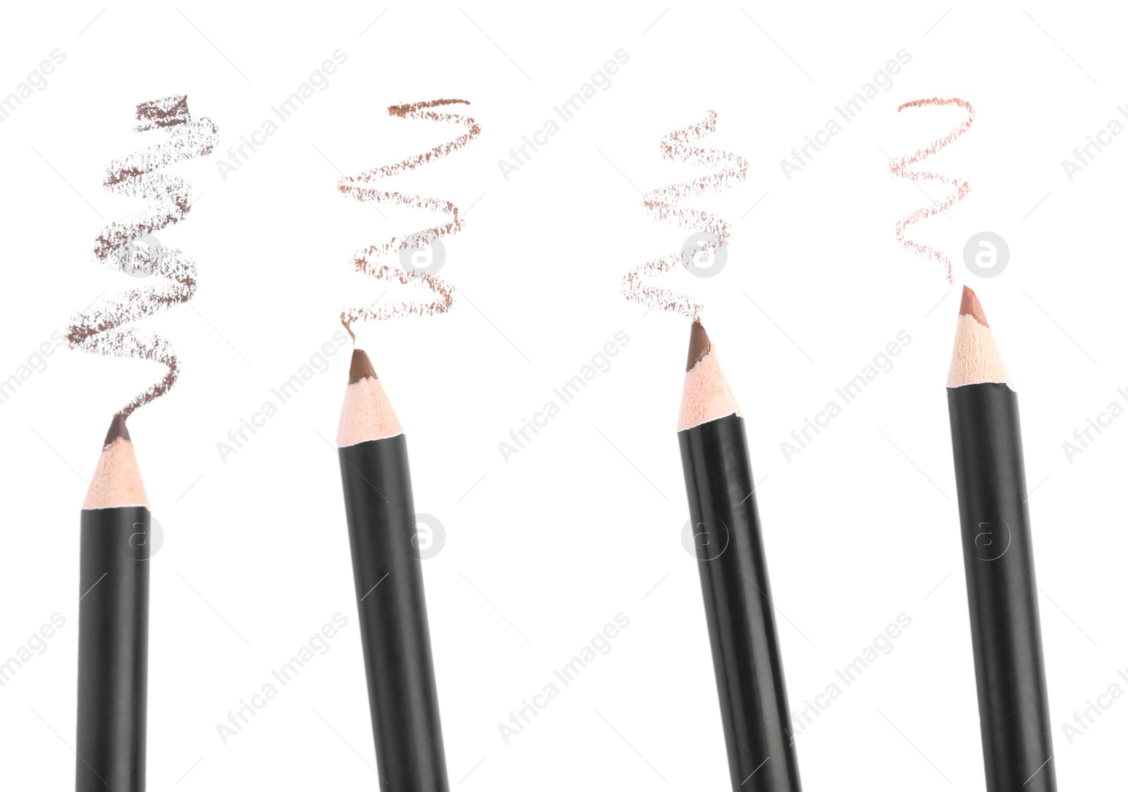 Eyebrow pencils and strokes isolated on white, top view Photo of Eyebrow pencils and strokes isolated on white, top view