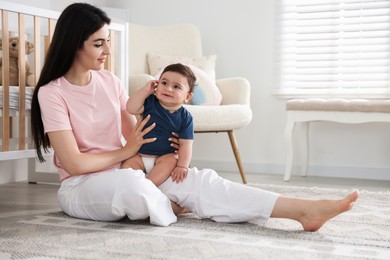 Photo of Happy mother with her cute little baby at home